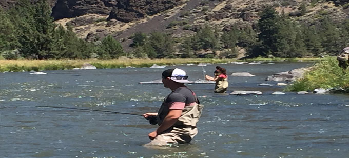 A young family fly fishing on the Crooked River, near Bend.