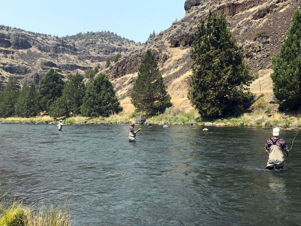 Clients fly fishing on the Crooked River near Bend, Oregon