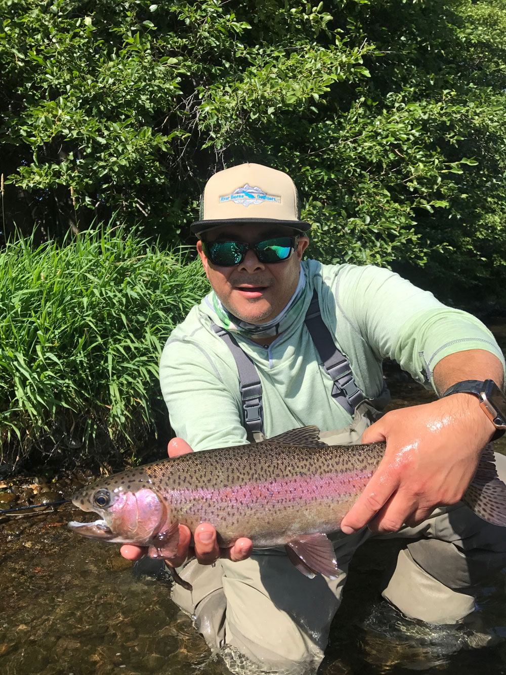 A client with a nice rainbow on a Deschutes River guided fly fishing trip.