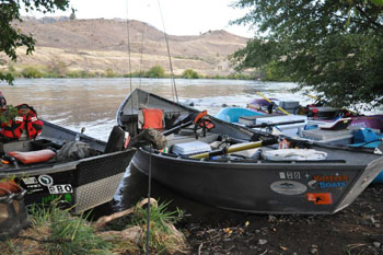 Drift boats and rafts tied up along the banks of the Lower Deschutes